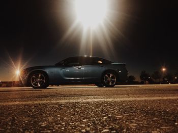 Cars parked on road at night