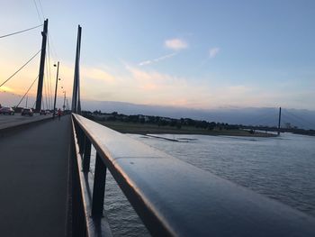 Bridge over river against sky during sunset