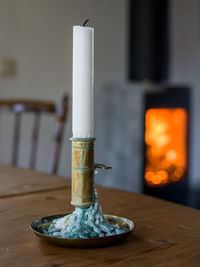 Close-up of illuminated candles on table