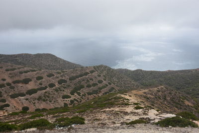 Scenic view of sea and mountains against sky