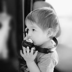 Portrait of cute boy holding outdoors