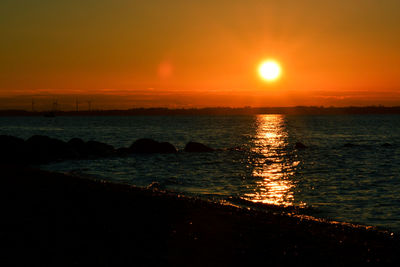 Scenic view of sea against romantic sky at sunset