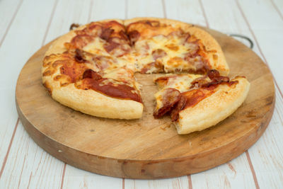 High angle view of pizza on cutting board