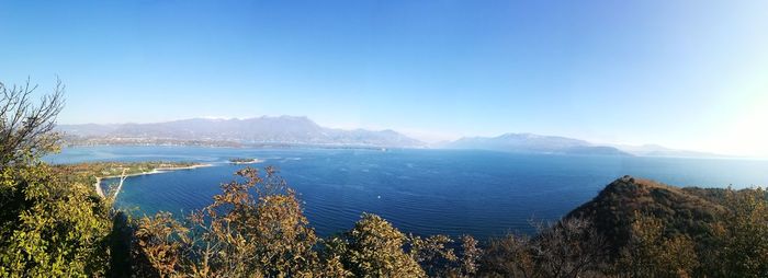 Scenic view of sea against clear blue sky