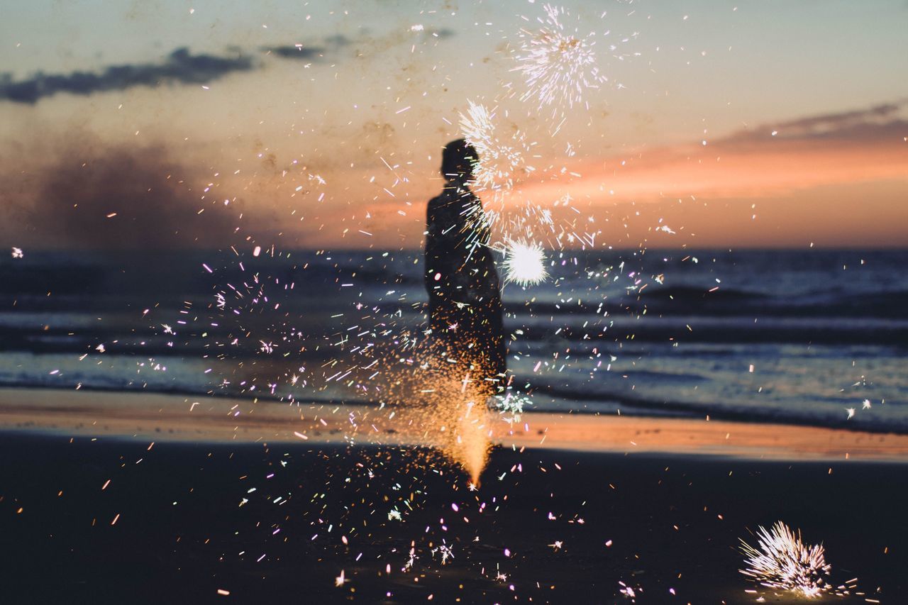 real people, one person, nature, lifestyles, motion, leisure activity, sky, outdoors, water, blurred motion, arts culture and entertainment, focus on foreground, illuminated, sunset, long exposure, silhouette, celebration, night, firework