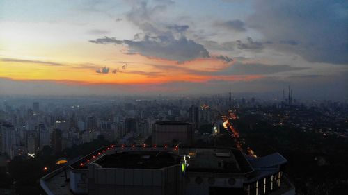 High angle view of illuminated buildings against sky during sunset