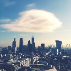 Cityscape against cloudy sky