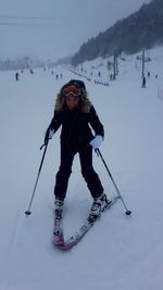 Man skiing on field during winter