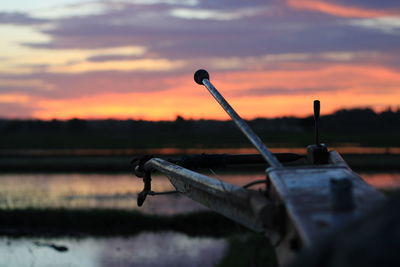 Close-up of old airplane against sky during sunset