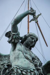 Low angle view of statue against sky