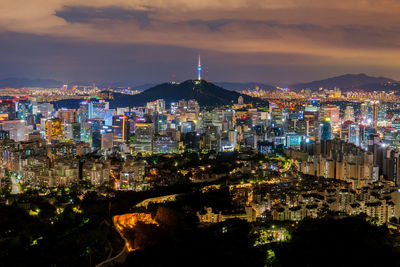 High angle view of city lit up at night