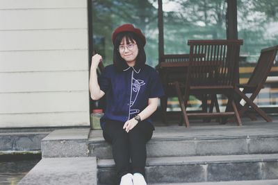 Portrait of young woman sitting outdoors