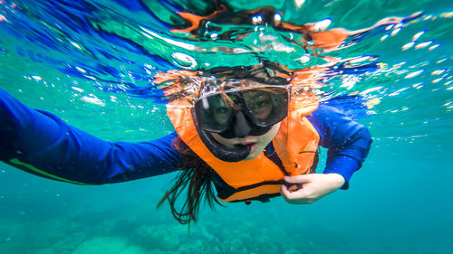 Woman scuba diving in sea