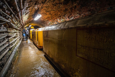 Man working in illuminated tunnel