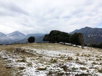 Scenic view of snow covered mountains against sky