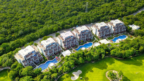 High angle view of buildings and trees in city