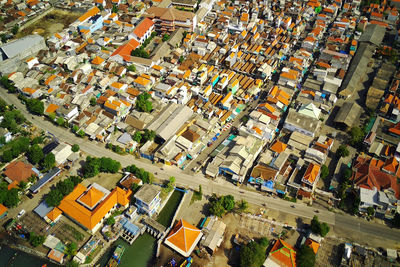 High angle view of crowd on street amidst buildings in city