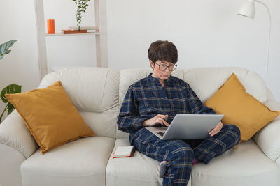 Young woman using laptop at home