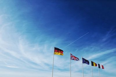 Low angle view of flag against blue sky