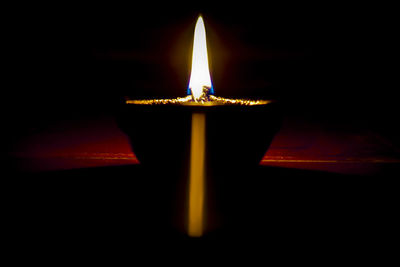 Close-up of illuminated lamp against black background