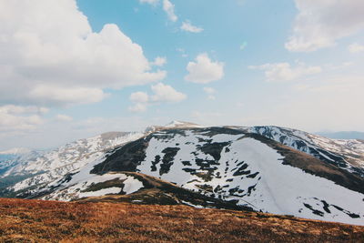 Scenic view of snowcapped mountains against sky