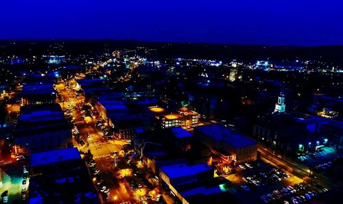 High angle view of illuminated cityscape against sky at night