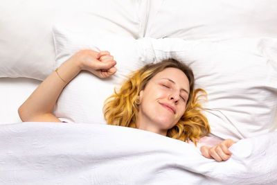 Young woman sleeping on bed at home