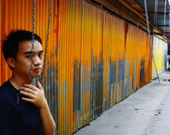 Young man holding chain