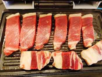 High angle view of meat on barbecue grill