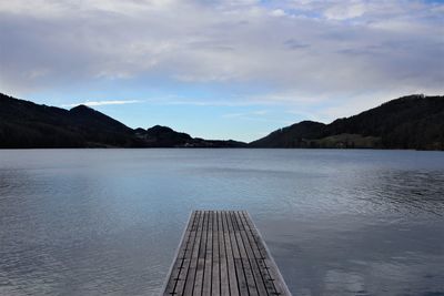 Pier over lake against sky