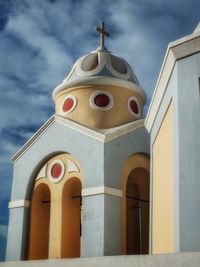 Low angle view of bell tower against sky