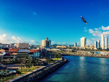 View of cityscape against clear blue sky