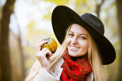 Smiling woman wearing sunhat outdoors