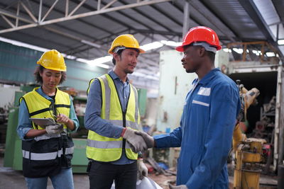 Rear view of people working at construction site