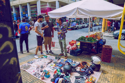 Group of people at market stall in city