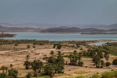 Scenic view of sea and mountains against sky