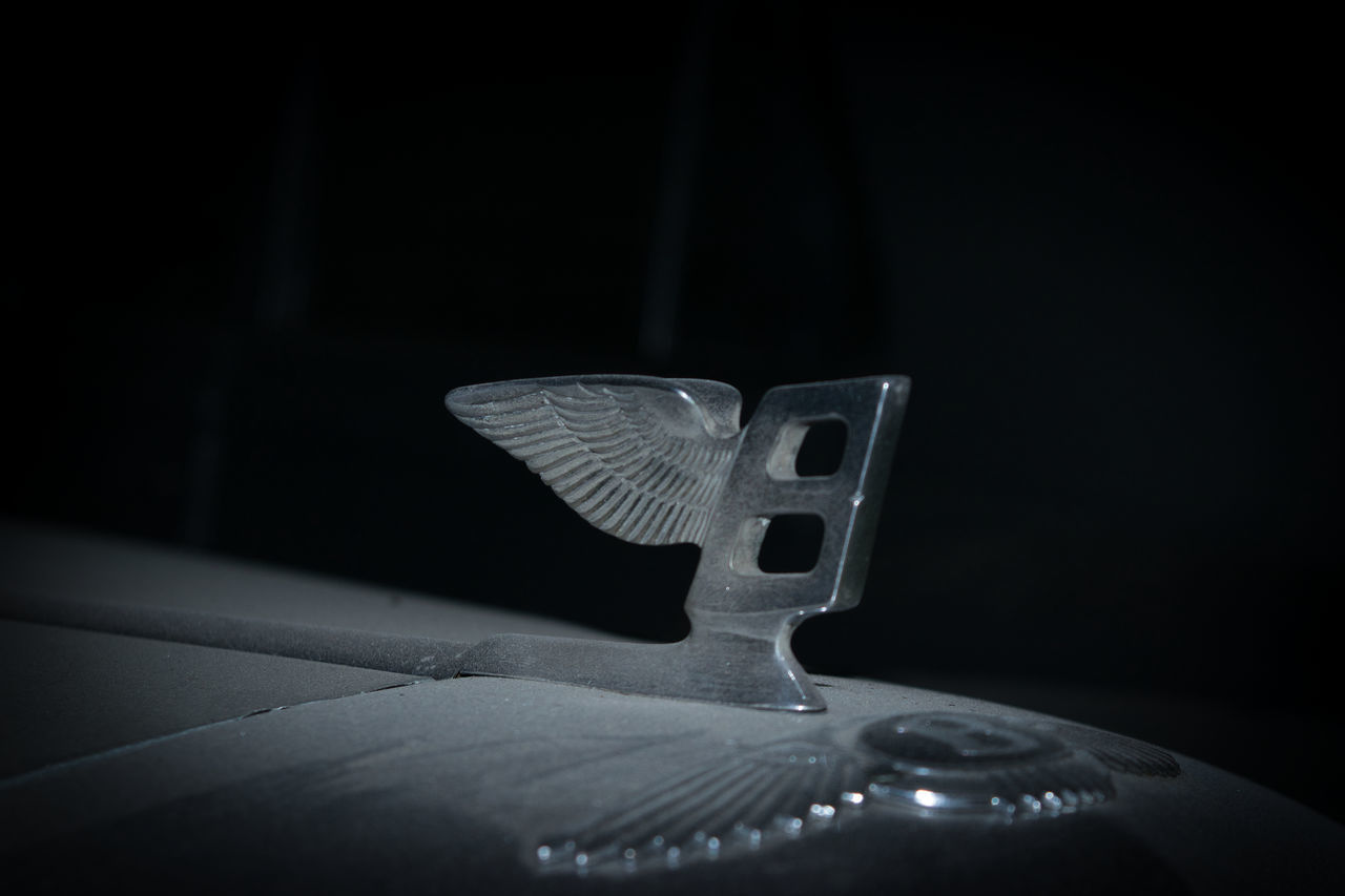 CLOSE-UP OF GUITAR IN BLACK BACKGROUND