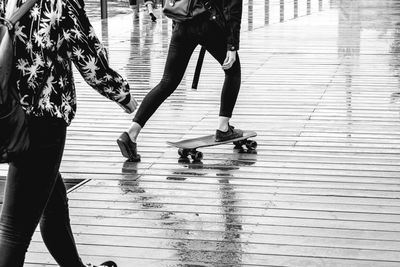 Low section of women walking on footpath