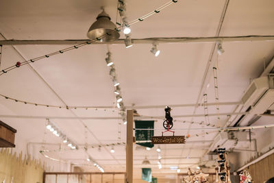 Low angle view of illuminated chandelier hanging on ceiling