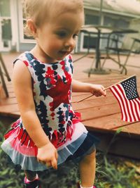 Close-up of cute girl with red flag