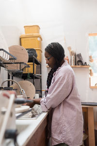 Woman washing her pottery at the ceramics studio