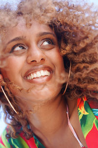 Low angle portrait of black woman with curly hair