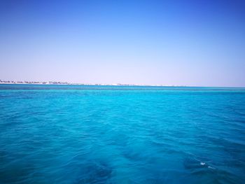 Scenic view of sea against clear blue sky