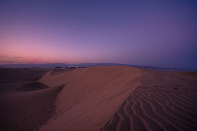 Scenic view of desert against sky during sunset