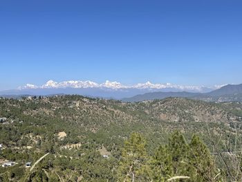 Scenic view of mountains against clear blue sky