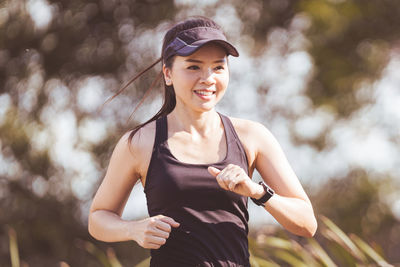 Portrait of smiling young woman standing outdoors