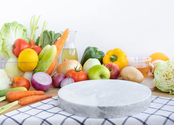 Various fruits in plate against white background