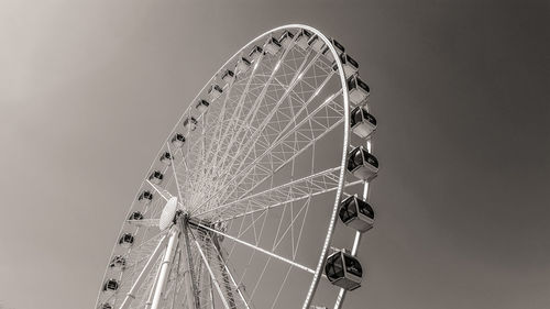 Low angle view of ferris wheel against sky