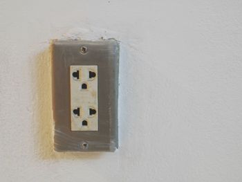 Close-up of electric lamp on wall