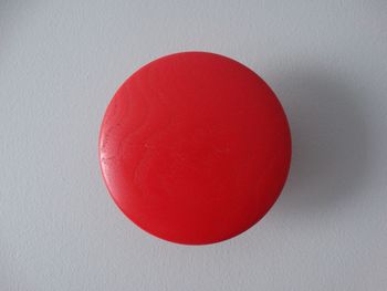 Close-up of red object over white background